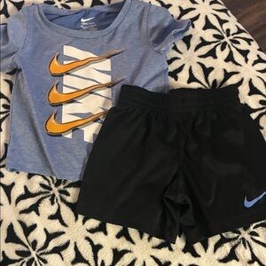 Nike Light Blue Tee with Gold Swoosh and Black Athletic Nike Shorts set